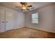 Comfortable bedroom with a ceiling fan, window, and closet space at 806 Jefferson Sw Ct, Conyers, GA 30094