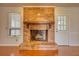 Close-up of the brick fireplace featuring a wooden mantle and hearth at 806 Jefferson Sw Ct, Conyers, GA 30094
