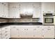 Classic kitchen featuring white cabinets, stainless steel appliances, and sleek countertops at 806 Jefferson Sw Ct, Conyers, GA 30094