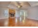 Inviting living room featuring a brick fireplace, hardwood floors, and a ceiling fan at 806 Jefferson Sw Ct, Conyers, GA 30094
