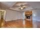 Bright living room featuring hardwood floors and a classic brick fireplace at 806 Jefferson Sw Ct, Conyers, GA 30094