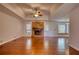 Spacious living room with hardwood floors, ceiling fan, and brick fireplace at 806 Jefferson Sw Ct, Conyers, GA 30094