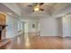 Large living room with hardwood floors, a ceiling fan, and a brick fireplace at 806 Jefferson Sw Ct, Conyers, GA 30094