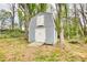 An outbuilding stands ready amidst mature trees, providing storage, workshop, or hobby space at 806 Jefferson Sw Ct, Conyers, GA 30094