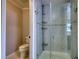 Modern bathroom featuring a tiled glass shower with shelving and fixtures at 806 Jefferson Sw Ct, Conyers, GA 30094