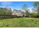 The backyard features a fenced in area, grass, and deck connected to the house at 313 Daniel Mill Xing, Villa Rica, GA 30180