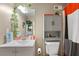 Cozy bathroom with gray vanity, decorative shelves, toilet, and a shower with patterned curtain at 313 Daniel Mill Xing, Villa Rica, GA 30180