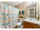Bathroom features a vanity, toilet, and tub with a patterned shower curtain at 313 Daniel Mill Xing, Villa Rica, GA 30180