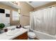 This bathroom has a single sink, toilet, and bathtub with shower in a traditionally decorated space at 313 Daniel Mill Xing, Villa Rica, GA 30180