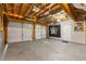 A spacious three car garage with exposed ceiling features and a painted floor at 313 Daniel Mill Xing, Villa Rica, GA 30180