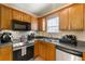 Well-equipped kitchen features stainless steel appliances and wood cabinetry at 313 Daniel Mill Xing, Villa Rica, GA 30180