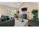 Cozy living room featuring a fireplace, vaulted ceilings, and a comfortable seating arrangement at 313 Daniel Mill Xing, Villa Rica, GA 30180