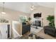 Bright living room with fireplace, vaulted ceiling, and view of front entry at 313 Daniel Mill Xing, Villa Rica, GA 30180