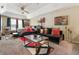 Spacious main bedroom with a ceiling fan, tray ceiling, and ample sitting area at 313 Daniel Mill Xing, Villa Rica, GA 30180