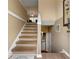 Bright staircase with hardwood steps and neutral walls, leading to an open living space at 313 Daniel Mill Xing, Villa Rica, GA 30180