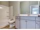 Bathroom featuring a shower-tub combo, and white cabinets at 3904 Shelleydale Dr, Powder Springs, GA 30127
