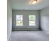This bedroom has neutral carpet and two windows with natural light at 3904 Shelleydale Dr, Powder Springs, GA 30127