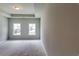 This bedroom has neutral carpet and two windows with natural light at 3904 Shelleydale Dr, Powder Springs, GA 30127