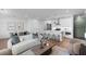 Bright, open-concept living room features a modern kitchen with stainless steel appliances and a cozy seating area at 554 Sawnee Village Blvd # D75, Cumming, GA 30040
