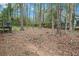 A partially fenced backyard with plenty of mature trees and room to play at 647 Sunshine Nw Trce, Acworth, GA 30102