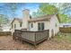 Back exterior of house with a wooden deck surrounded by fall leaves at 647 Sunshine Nw Trce, Acworth, GA 30102