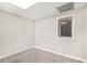 Neutral painted basement room with carpeted floor and a single window with blinds at 647 Sunshine Nw Trce, Acworth, GA 30102