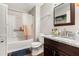 Bathroom features a tub with shower, grey and white marble countertop with a wood vanity and a framed mirror at 647 Sunshine Nw Trce, Acworth, GA 30102
