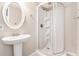 Bathroom features a pedestal sink and round shower with white tiles and a door at 647 Sunshine Nw Trce, Acworth, GA 30102