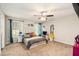 Bedroom featuring a ceiling fan, two windows, and carpet flooring at 647 Sunshine Nw Trce, Acworth, GA 30102