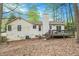 Exterior view of home featuring a wood deck with staircase and mature trees at 647 Sunshine Nw Trce, Acworth, GA 30102