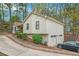 Exterior side view of a well-maintained home with attached garage and landscaped yard at 647 Sunshine Nw Trce, Acworth, GA 30102