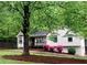 Charming home with a well-maintained front yard, mature tree, mulch bed, and a cozy front porch at 647 Sunshine Nw Trce, Acworth, GA 30102
