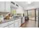 Bright kitchen features white cabinets, granite counters, stainless steel appliances, and access to an outdoor deck at 647 Sunshine Nw Trce, Acworth, GA 30102