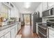 Modern kitchen with stainless steel appliances, granite countertops, and a view to the outdoor deck at 647 Sunshine Nw Trce, Acworth, GA 30102