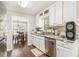 Well-lit kitchen featuring stainless steel appliances, granite countertops, and wood-look flooring at 647 Sunshine Nw Trce, Acworth, GA 30102