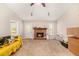 Bright living room featuring a brick fireplace, a ceiling fan, and plush carpet flooring at 647 Sunshine Nw Trce, Acworth, GA 30102