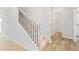 Carpeted staircase with dark metal spindles and light wood handrail at 7194 Brushwood Bend - Lot 116, Lithonia, GA 30058