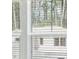 Close-up of a white window with a view of a neighborhood at 7194 Brushwood Bend - Lot 116, Lithonia, GA 30058