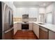 Modern kitchen featuring stainless steel appliances, gray cabinets, and dark hardwood floors at 1155 Custer Se Ave # 209, Atlanta, GA 30316