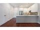 Open-concept living area featuring hardwood floors and a modern kitchen with stainless steel appliances at 1155 Custer Se Ave # 209, Atlanta, GA 30316