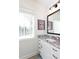 Bathroom features granite counters, white cabinets with black hardware, and natural light from a window at 1515 Walker Ave, Atlanta, GA 30337