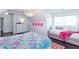Bedroom showcases a light fixture, colorful bedspread, and a geometric patterned rug at 1515 Walker Ave, Atlanta, GA 30337