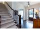 Elegant foyer with hardwood floors, staircase, and a view into the living room at 1515 Walker Ave, Atlanta, GA 30337