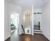Well-lit hallway with dark wood floors and staircase at 1515 Walker Ave, Atlanta, GA 30337