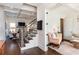 A modern living room featuring hardwood floors, a staircase, and elegant furniture at 1515 Walker Ave, Atlanta, GA 30337