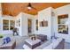 Covered patio featuring a wood ceiling, ceiling fans, and an outdoor seating area with a TV at 1515 Walker Ave, Atlanta, GA 30337