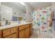 bathroom features a dinosaur-themed shower curtain and ample counter space at 2705 Maple Park Pl # 29, Cumming, GA 30041