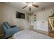 Bedroom with a ceiling fan, wall-mounted TV, and an armchair at 2705 Maple Park Pl # 29, Cumming, GA 30041