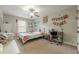 Comfortable bedroom with ceiling fan, desk and chair, and decorations on the wall at 2705 Maple Park Pl # 29, Cumming, GA 30041