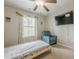 Bedroom with a ceiling fan, natural light, and a blue armchair at 2705 Maple Park Pl # 29, Cumming, GA 30041